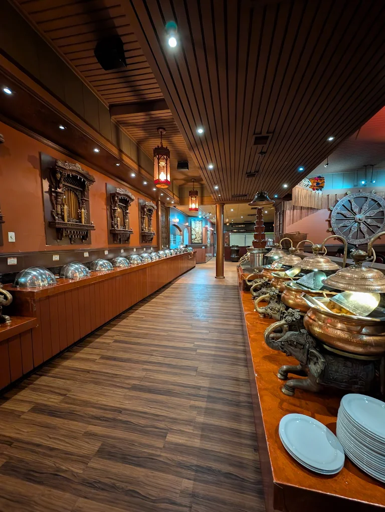 All-you-can-eat Indian buffet with copper serving vessels at New Asian Village West Edmonton